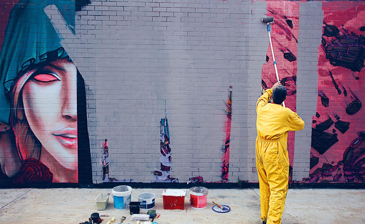 Man paints over grafitti